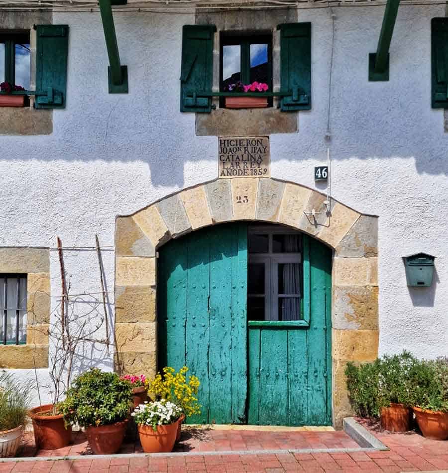 green painted door of a basque village house in Espinal