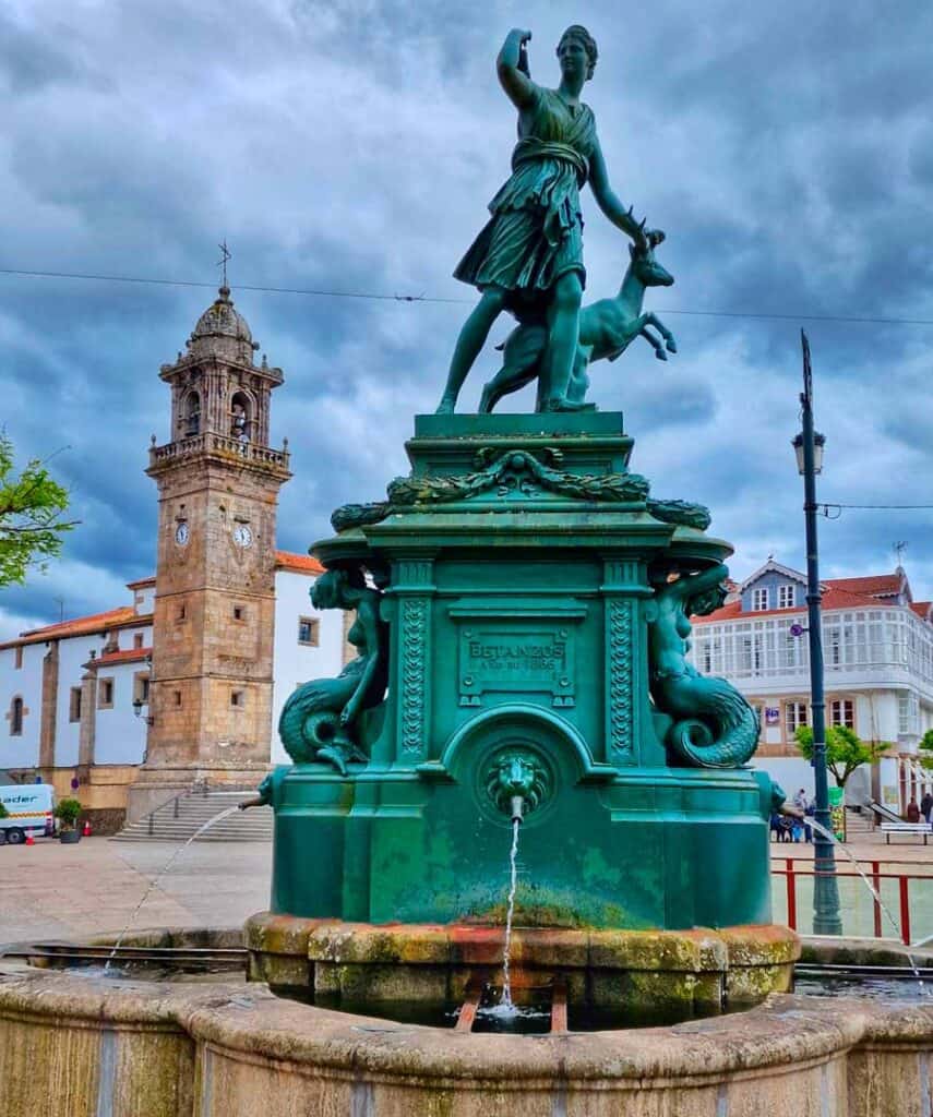 the town square in the heart of old Betanzos, with a fountain and church behind