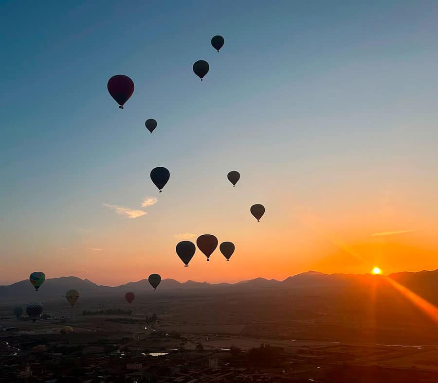view of sunrise over the atlas mountains from a hot air balloon