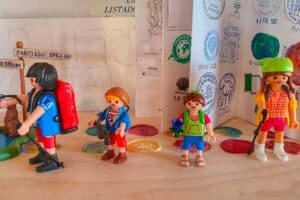 lego pilgrims beside a pilgrim credential