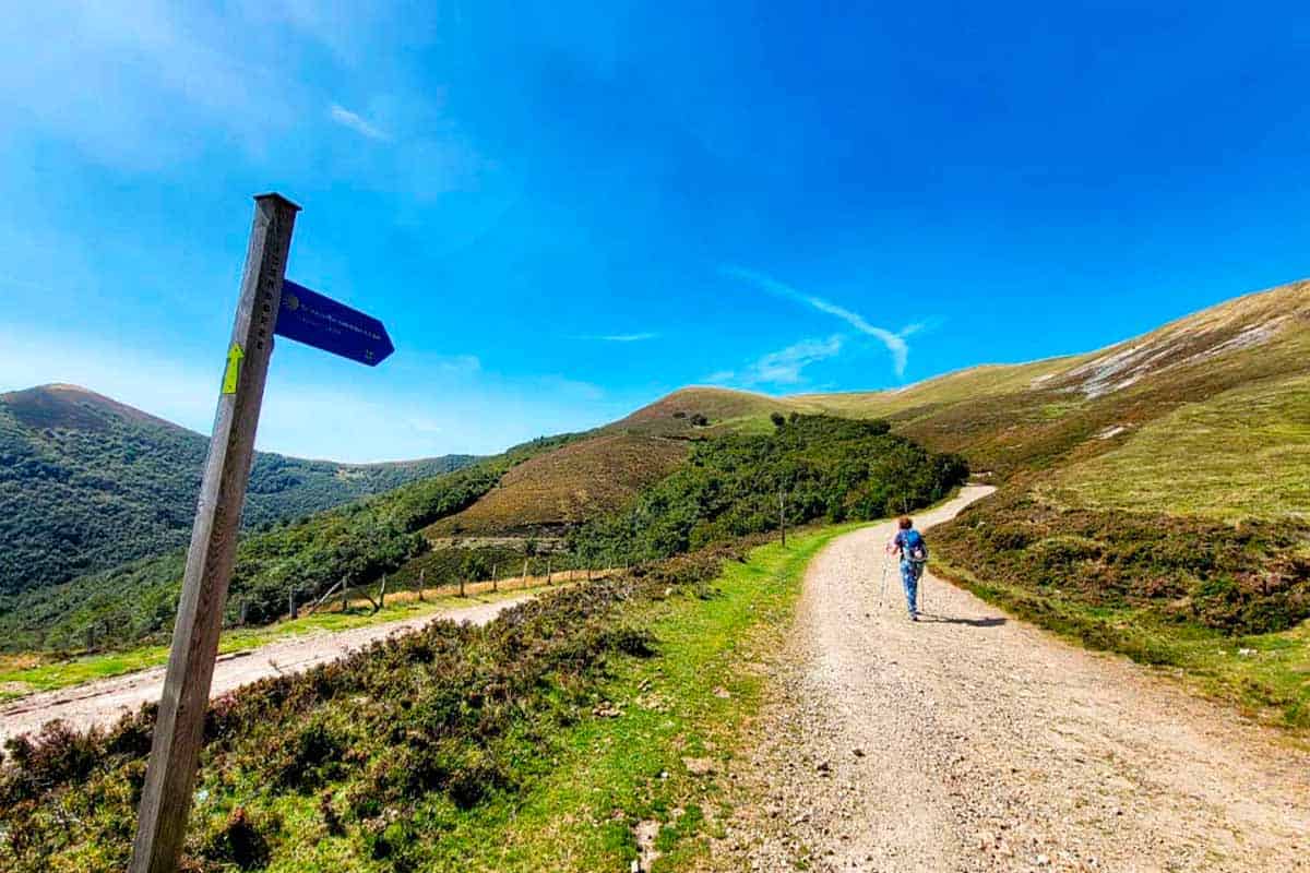 a pilgrim following arrows along the camino de santiago