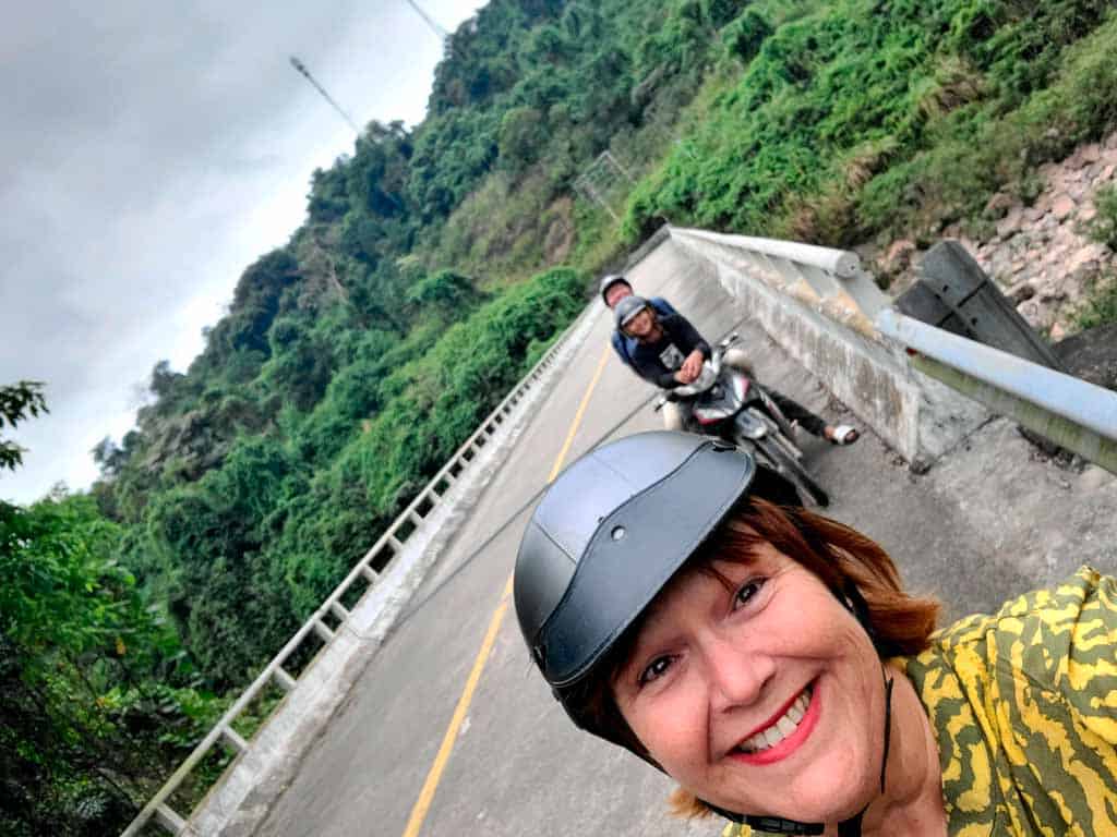 colleen taking a photo from her motorbike whilst on an easyrider tour of Phong Nha