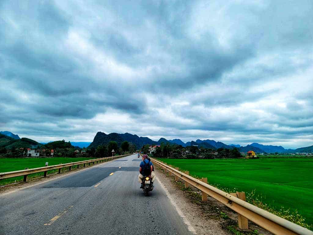 gerry riding along the flat roads around the rice paddies of phong nha