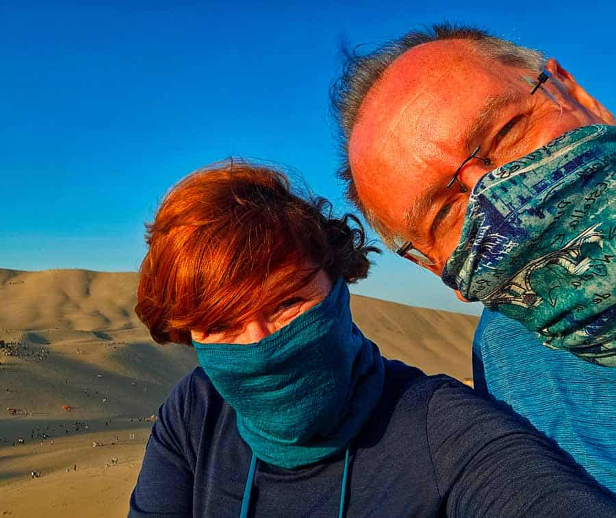 colleen and gerry wearing buffs to stop the sand from blowing in their faces