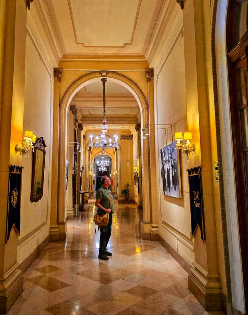 Gerry in the stunning hallways and chandeliers in Grand hotel Bolivar