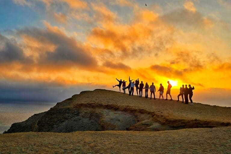 our group posing during the sunset on the cliffs during our golden shadows trek