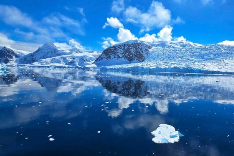 stunning blue sky reflected in the still water of Antarctica