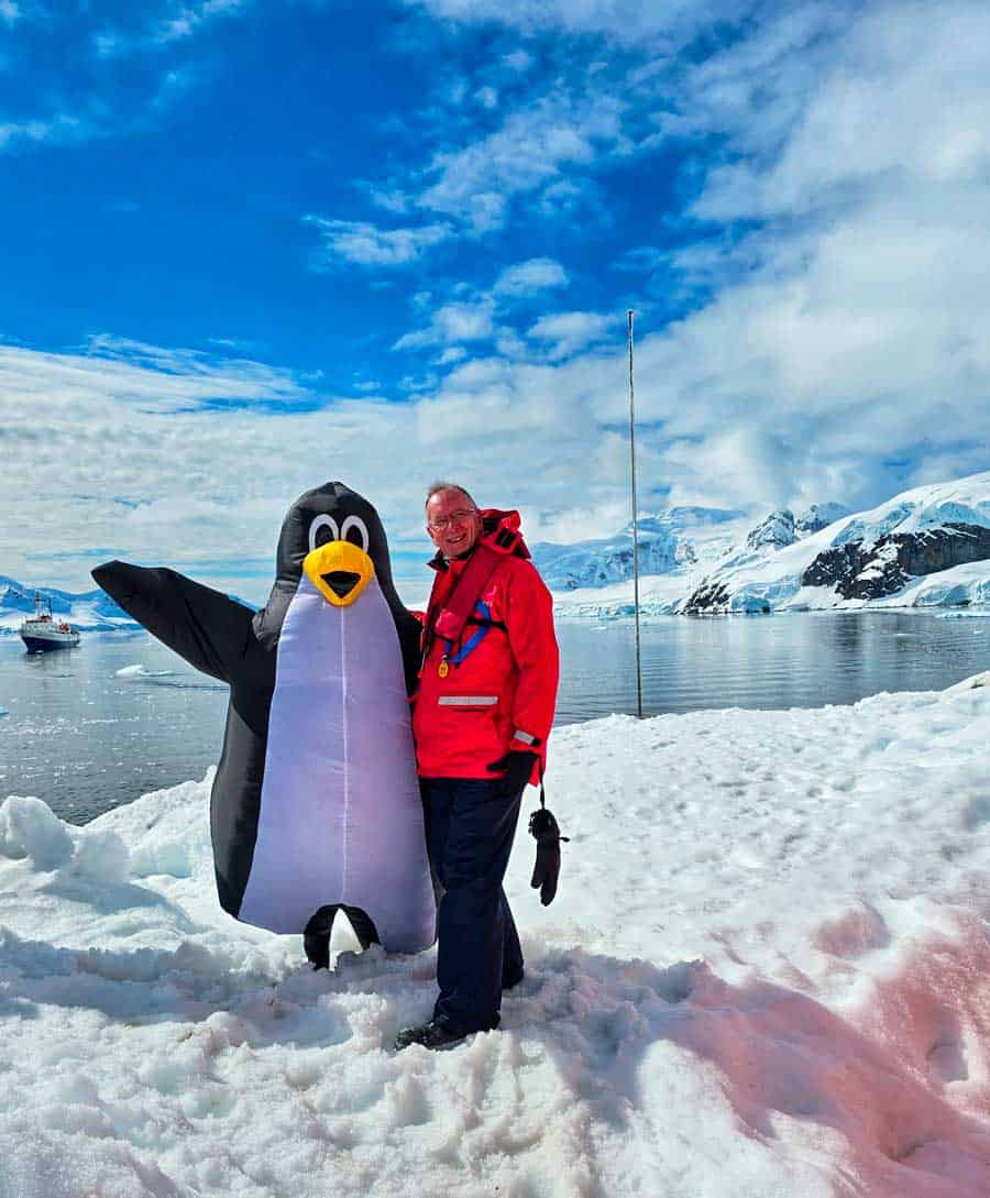 Gerry with a crew member dressed as a penguin