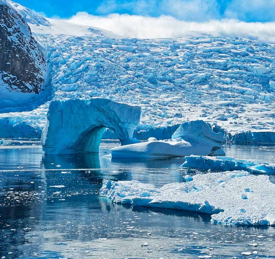 incredible natural arch formed in an iceberg