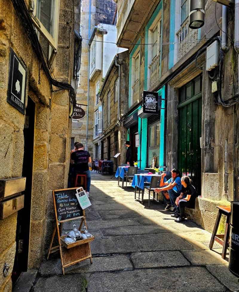 narrow street with cafe in the old town of vigo
